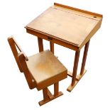 A mid 20thC ash child's desk, with matching chair.