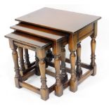 An Old Charm style nest of oak occasional tables, largest table 48cm high, 52cm wide, 35cm deep.