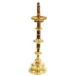 A Victorian brass altar candlestick, converted to electricity, 79ccm high.