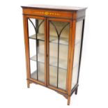 An Edwardian mahogany boxwood inlaid and painted display cabinet, with a pair of astragal glazed doo