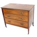 An Edwardian mahogany chest, of three long graduated drawers, raised on tapering square legs, brass