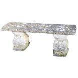 A concrete garden bench, with a rectangular seat, raised on a pair of leaf scroll supports, 124cm wi
