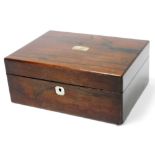 A Victorian rosewood sewing box, with mother of pearl escutcheons, opening to reveal a watered silk