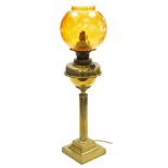 A Young's brass oil lamp, converted to electricity, of fluted column form, raised on a stepped squar