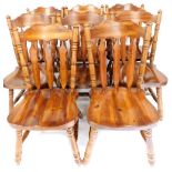 A set of eight stained pine dining chairs, with loose cushion seats, comprising a pair of carvers an