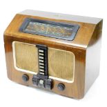 A mid 20thC HMV 1117 wooden cased radio, with long, medium and short waves, 49cm wide. Buyer Note: W