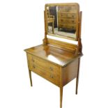 An Edwardian mahogany and inlaid dressing chest, the swing frame mirror above two frieze drawers, ra