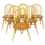 A set of six Ercol Windsor light elm and beech dining chairs, with H stretcher, raised on cylindrica