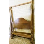 An oak double half tester bed, with iron side rails.