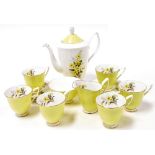 A Royal Albert porcelain part coffee service, decorated with yellow primroses, comprising coffee pot