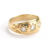 A gold ring, set with three diamonds in a textured shank, size K, 3.1g.