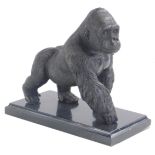 A 20thC bronze figure of a gorilla, on a marble finish plinth base, unsigned, 20cm high.