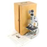 A Prinz Optics student microscope, model 300L 80x x 1200x in box, with paperwork, 25m high.