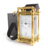 Rapport London. A gilt brass carriage clock with 5cm wide plate with Roman numeric and Arabic dial a