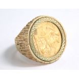 A Victorian gold full sovereign ring, in a textured 9ct gold setting, size V, 18g all in.