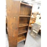 A rustic pine stained freestanding open bookcase.