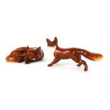 Two Beswick fox ornaments, comprising a curled up fox, 9cm wide, and a small strolling fox, 6cm high
