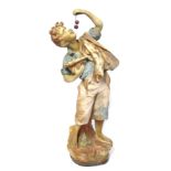 A terracotta figure of a child, carrying fruits and with detachable hand with berries, 69cm high.