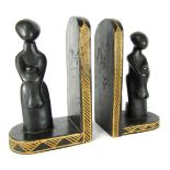 Tribal Art. A pair of carved and ebonised hardwood bookends, each depicting a mother and child, 27cm