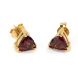 A pair of 9ct gold ruby stud earrings, each with triangle cut ruby, in claw setting stamped 375 with