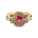 A 9ct gold dress ring, the cluster set with central red paste stone surrounded by white paste stone