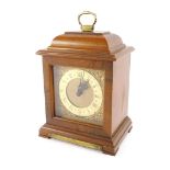 A walnut cased Rotherham's mantel clock, the carved three point top above a gold dial with cherub sp