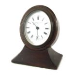 A Thornhill & Co of London desk clock, the shaped oval top with white ceramic dial, bearing Roman nu