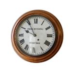A mahogany bezel wall clock, with Roman numerals and marked FRANK MITCHELL STAMFORD, 42cm diameter.