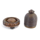 A 19thC lignum vitae string box, shaped as an acorn with rosette top, on carved base with tripod fee