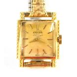 An 18ct gold Enicar ladies wristwatch, the square wristwatch head with concave glass, on a silvered