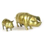 Two brass pig money boxes, comprising a large example 16cm high, the other 9cm high.