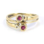 A 9ct gold ruby and diamond dress ring, of two twist design set with two rubies and a single diamond