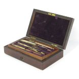 A late 19thC drawing instrument cased set, the top layer with multiple tools and a fitted and lined