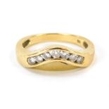 An 18ct gold diamond wishbone ring, set with seven tension set round brilliant cut stones, totalling