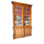 A Victorian Gothic oak cabinet bookcase, with moulded cornice, two tall astragal glazed doors, with