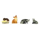 Four Beswick animal ornaments, comprising two badgers, a ginger cat, and a mouse on corn, the larges