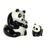 Two Panda ornaments, comprising a Beswick panda, 5cm high, and a Wade panda money box, 12cm high.