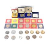 A group of collector's coins, comprising a Republic of Ghana $1 coin, a One Leon and Two Leon coin,