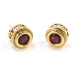 A pair of 9ct gold garnet earrings, of circular design on raised and pierced basket, stamped 375, wi