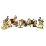 A group of bird ornaments, comprising an Artista Designs dog, a seated dog with boot, Beswick bird,