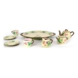 A French majolica tete a tete, comprising serving tray, milk jug, sugar bowl, two cups and saucers,