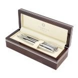 A Sheaffer Signature pen set, comprising biro and pencil, in a chrome finish with wooden gloss case.