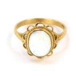 A 9ct gold opal dress ring, in a floral cluster with single oval opal in a rub over setting, with ro