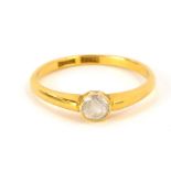 A diamond solitaire ring, with old cut tiny diamond in a rub over setting on a yellow metal band mar