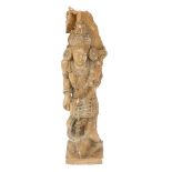 A carved Indian figure of a Goddess, on a book base, 97cm high. (AF)