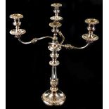 A Victorian electroplated candelabrum, with gadrooned sconces and bases and leaf formed baluster ste