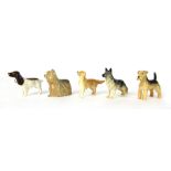 Five Beswick dog ornaments, comprising a Retriever, Yorkshire Terrier, Cocker Spaniel (brown), Alsat