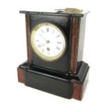 A 19thC French black slate mantel clock, the shaped top on two column supports, with applied red mar