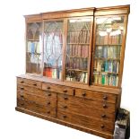 An early 19thC flamed mahogany break front cabinet and secretaire bookcase, with moulded cornice, Go