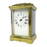 A brass cased carriage clock, the white enamel dial with Roman numeral chapter ring and single blue